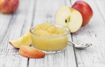 Portion of homemade Applesauce (selective focus, close-up shot) on vintage background