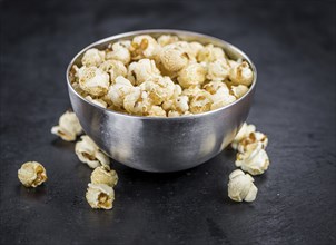 Fresh made Popcorn on a vintage background as detailed close-up shot