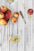 Portion of fresh made Applesauce (selective focus) on a wooden table