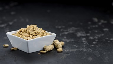 Portion of roasted and salted Peanuts (close-up shot, selective focus)