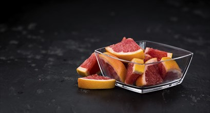 Chopped Grapefruits (selective focus) on a vintage background as detailed close-up shot