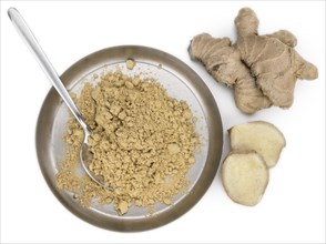 Ground Ginger as detailed close-up shot isolated on white background (selective focus)