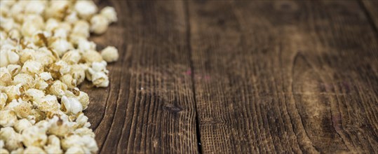 Fresh made Popcorn on a vintage background as detailed close-up shot