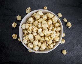 Some Popcorn on a slate slab as detailed close-up shot, selective focus