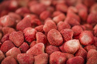 Dried Strawberries on rustic wooden background as close-up shot