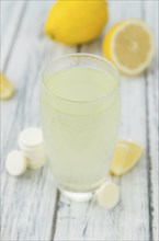 Vitamin C Tablets as high detailed close-up shot on a vintage wooden table, selective focus