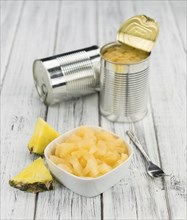 Preserved Pineapple pieces on a vintage background as detailed close-up shot, selective focus