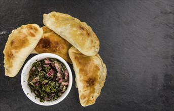 Healthy Empanadas on a vintage slate slab (close-up shot, selective focus)