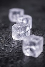 Some melting Ice cubes on a vintage slate slab (selective focus)