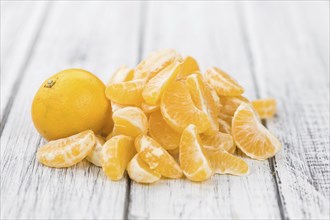 Raw Tangerine pieces (close-up shot) on vintage background