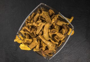 Portion of Preserved chanterelles as detailed close up shot on a slate slab, selective focus