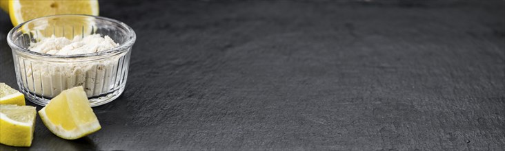 Portion of healthy Lemon powder on a slate slab (selective focus)