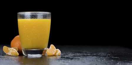 Fresh made Tangerine Juice on a vintage slate slab (selective focus)