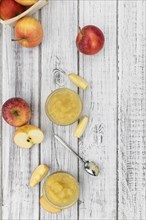 Old wooden table with fresh made Applesauce (selective focus, close-up shot)