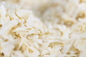 Coconut Chips (fresh) as detailed close-up shot, selective focus)