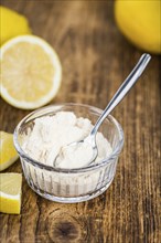 Wooden table with Lemon powder (detailed close-up shot, selective focus)