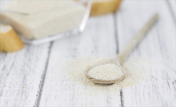 Wooden spoon with Breadcrumbs (close-up shot, selective focus) on an old wooden table