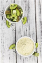 Fresh made Kiwi powder (slective focus, close-up shot) on an old wooden table