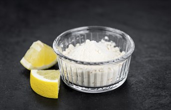 Portion of healthy Lemon powder on a slate slab (selective focus)