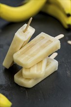 Banana Popsicles on a vintage background (close-up shot, selective focus)