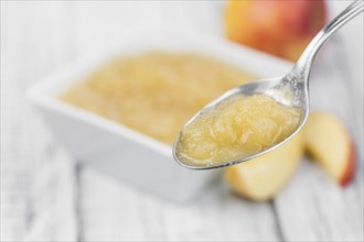 Portion of homemade Applesauce (selective focus, close-up shot) on vintage background