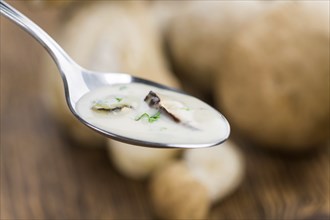 Portion of fresh Porcini Soup close-up shot, selective focus