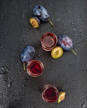 Plum Liqueur on a vintage slate slab as detailed close-up shot, selective focus