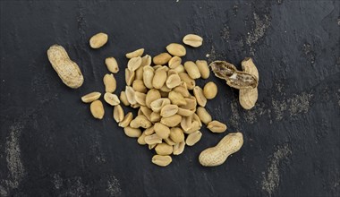 Portion of roasted and salted Peanuts (close-up shot, selective focus)