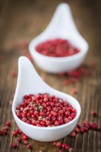 Pink Peppercorns on a vintage background as detailed close-up shot, selective focus