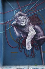 Lion hanging in ropes, mural by Greek street artist Nikolaos Tsounakas, Psirri neighbourhood,