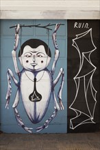 Bizarre beetle with human head, graffiti by Greek street artist Ruin, Psirri neighbourhood, Athens,