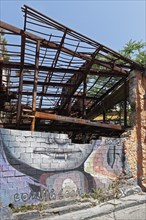 Ruins of a taverna with graffiti of a vampire, Coming. Soon, Psirri neighbourhood, Athens, Greece,