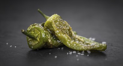 Pimientos de Padron on a vintage background as detailed close-up shot, selective focus