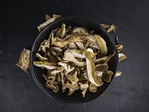 Dried Porcinis on a vintage slate slab as detailed close-up shot, selective focus