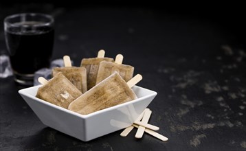 Cola Popsicles (selective focus) on a vintage background as detailed close-up shot