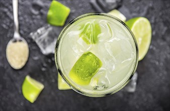 Slate slab with Caipirinha (selective focus, close-up shot)