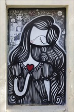 Female figure with red heart, graffiti by Greek street artist Sonke, Exarchia neighbourhood,