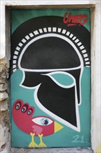 Greek helmet and bizarre bird, graffiti by street artist Uneg, Plaka historic centre, Athens,