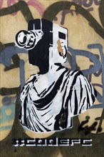 Greek statue with film camera as head, graffiti by street artist Goin, Plaka Old Town, Athens,