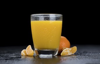 Tangerine Juice (close-up shot) on a vintage looking slate slab