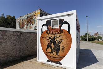 Greek amphora with scene from Greek mythology, fighting Heracles, graffiti painted on construction