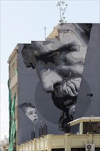 Old man and child looking at each other, two generations, symbol of the future, mural in scarlet