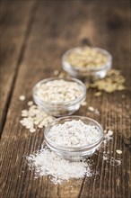 Vintage wooden table with Oat Flour (selective focus, close-up shot)