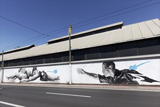 Man reaching for woman in bikini with diving mask, surreal mural in black and white by Greek street