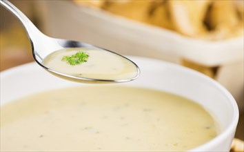 Portion of fresh Chanterelle Soup close-up shot, selective focus