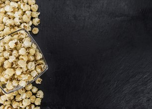 Fresh made Popcorn on a vintage background as detailed close-up shot