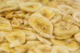 Fresh made Dried Banana Chips on an old and rustic wooden table, selective focus, close-up shot