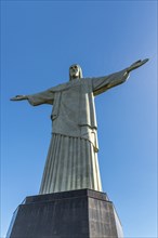 Christ the Redeemer statue in Rio de Janeiro, Brazil with blue sky in the background