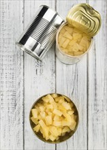 Fresh made Chopped Pineapple (preserved) on an old and rustic wooden table, selective focus,