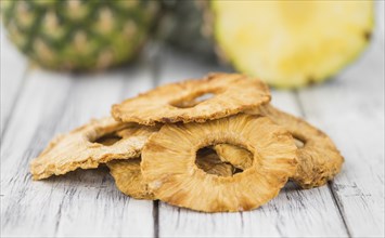 Dried Pineapple Rings on a vintage background as detailed close-up shot, selective focus